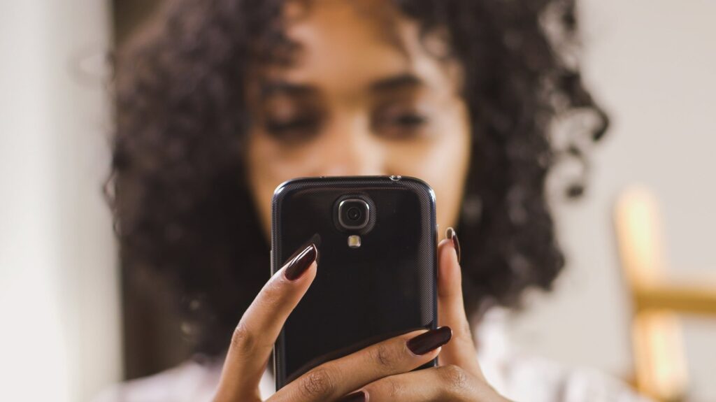 woman holding mobile device