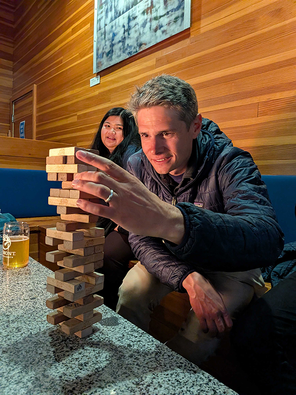 teammates playing a giant game of Jenga